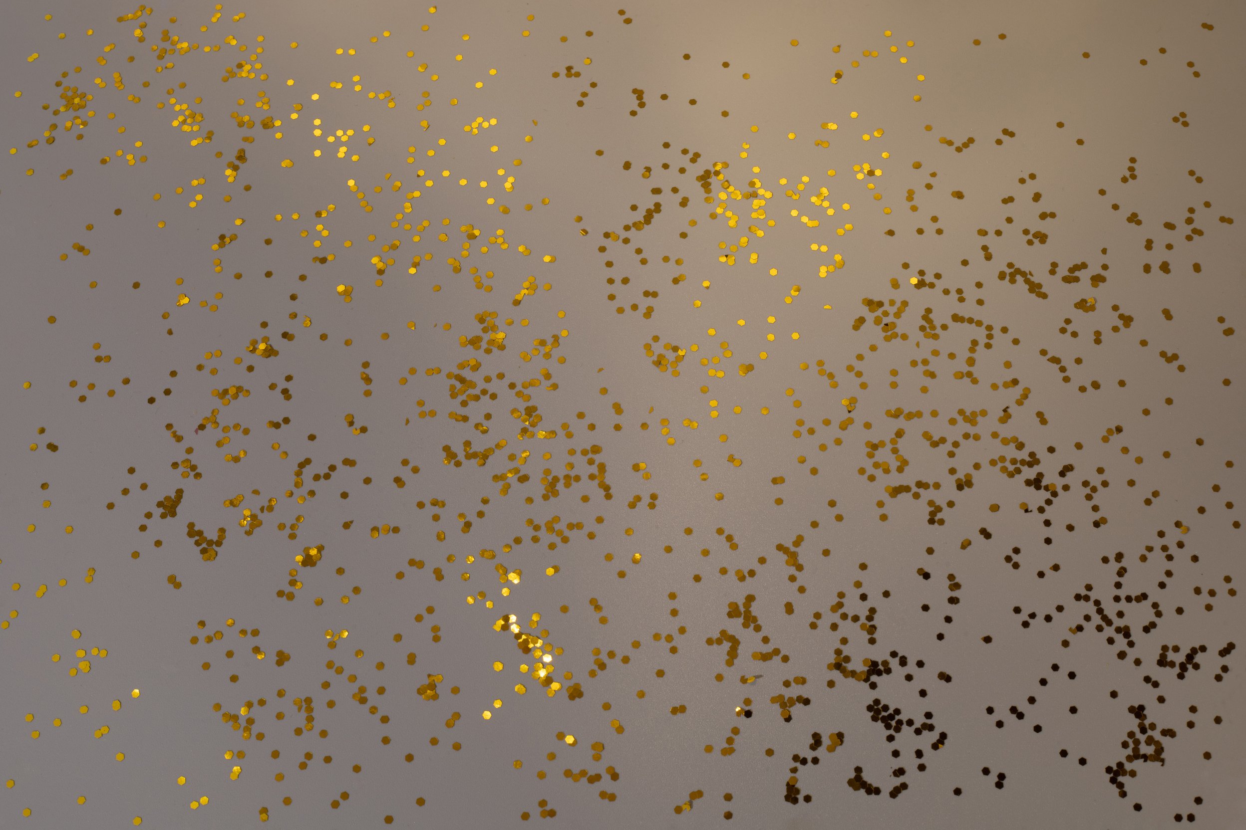 Golden Glitter Confetti on Gray Background